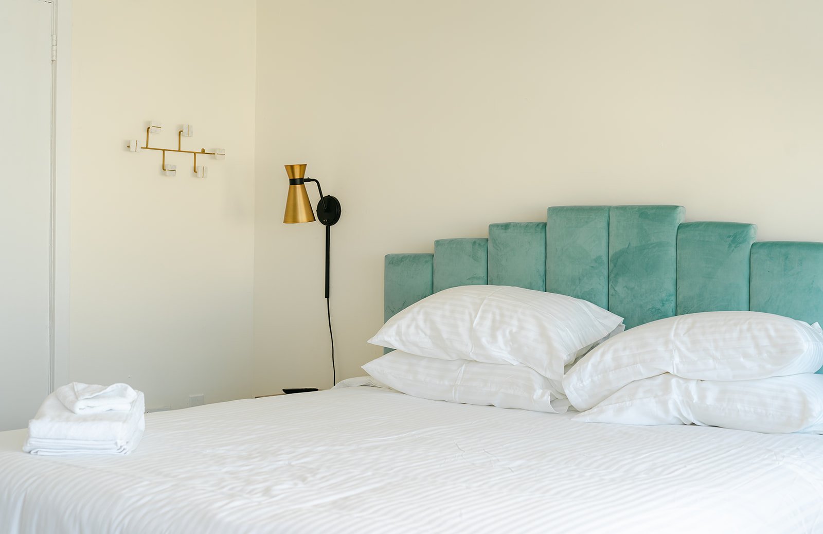 Cozy King room with teal velvet headboard